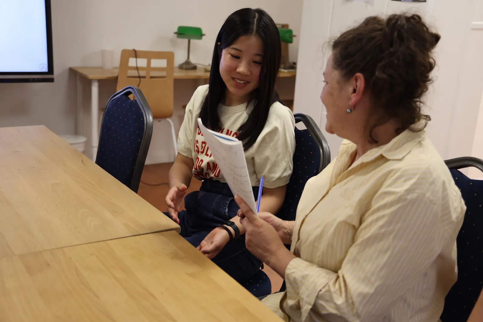 A teacher helping a student prepare for a French exam in Paris